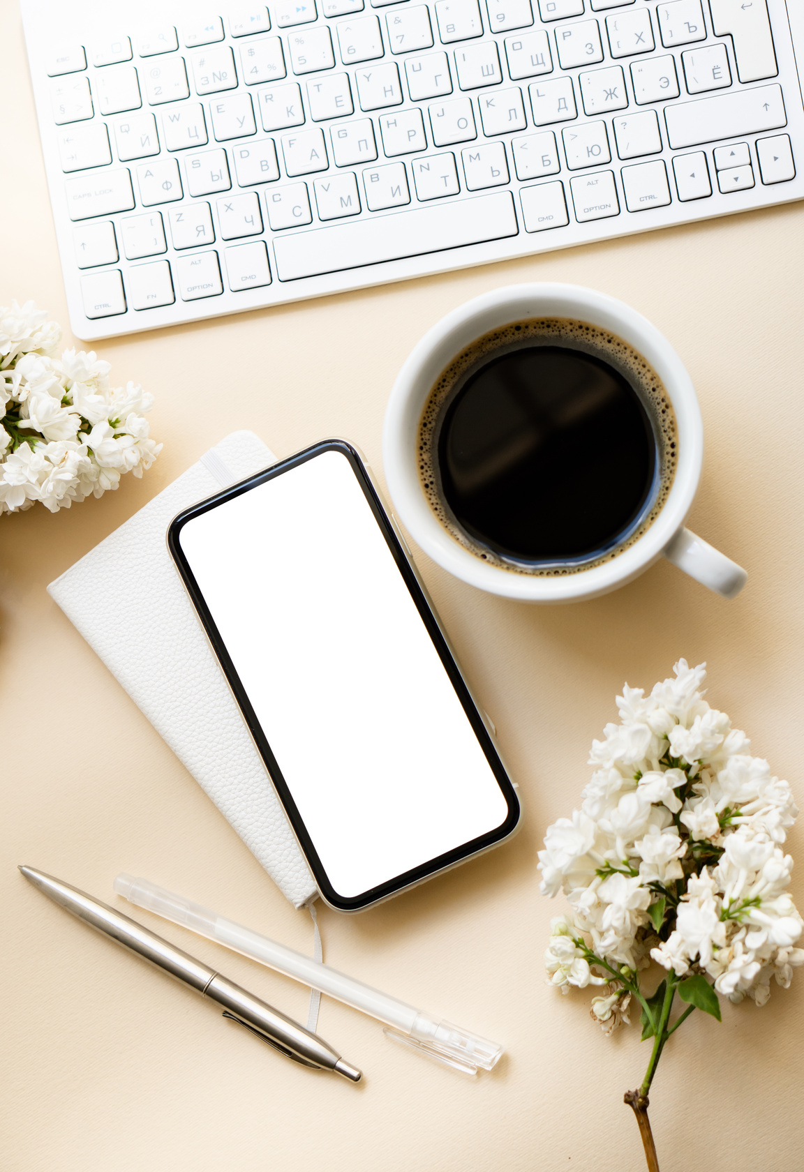 Keyboard with Coffee and Smartphone on Neutral Background